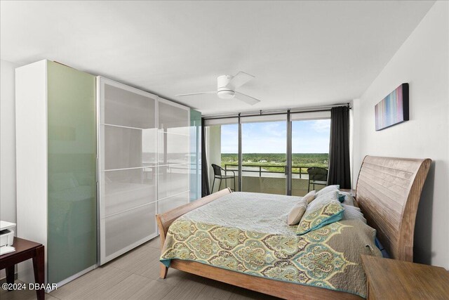 bedroom with floor to ceiling windows, ceiling fan, and access to exterior