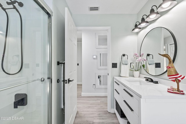 30 Bay Ct, Ormond Beach, FL 32174 - bathroom with a shower stall, vanity, and wood finished floors