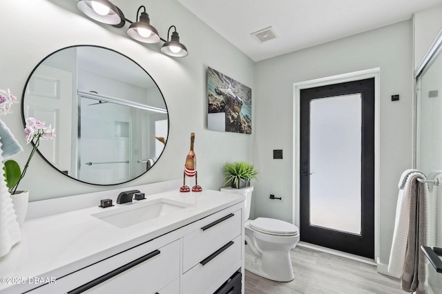 30 Bay Ct, Ormond Beach, FL 32174 - bathroom with vanity, wood finished floors, and a shower with shower door