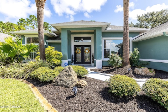 30 Bay Ct, Ormond Beach, FL 32174 - entrance to property with stucco siding, french doors, and roof with shingles