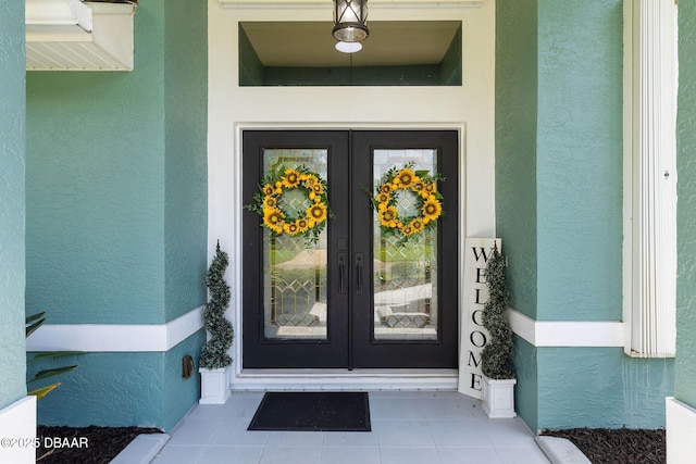 30 Bay Ct, Ormond Beach, FL 32174 - doorway to property with french doors and stucco siding