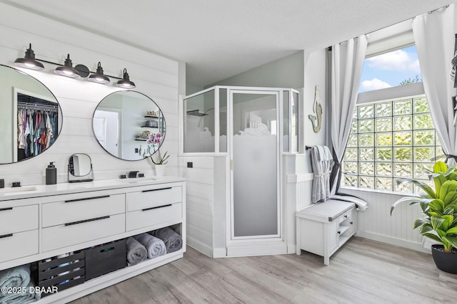 30 Bay Ct, Ormond Beach, FL 32174 - bathroom featuring a stall shower, wood finished floors, and double vanity