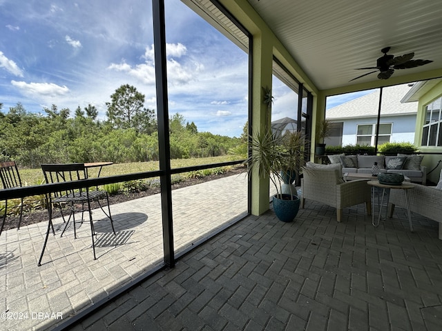 sunroom / solarium featuring ceiling fan