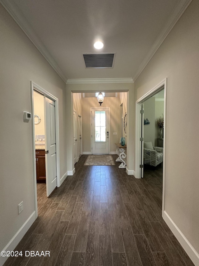 living room featuring ornamental molding, ceiling fan with notable chandelier, a raised ceiling, and dark wood-type flooring