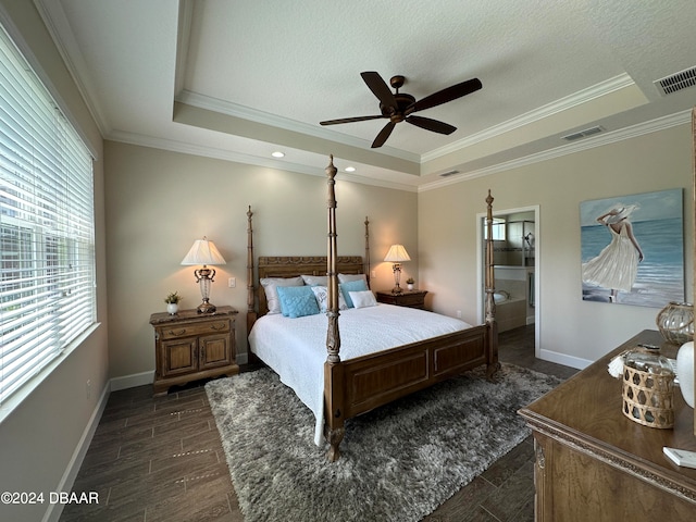 bedroom with dark wood-type flooring, a raised ceiling, crown molding, ceiling fan, and a textured ceiling