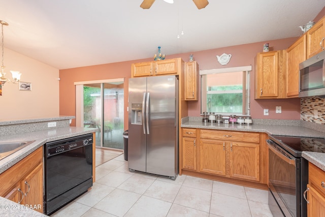 kitchen with light stone counters, ceiling fan with notable chandelier, black appliances, light tile patterned floors, and hanging light fixtures