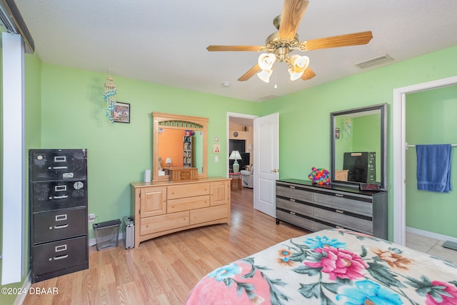 bedroom with light wood-type flooring and ceiling fan