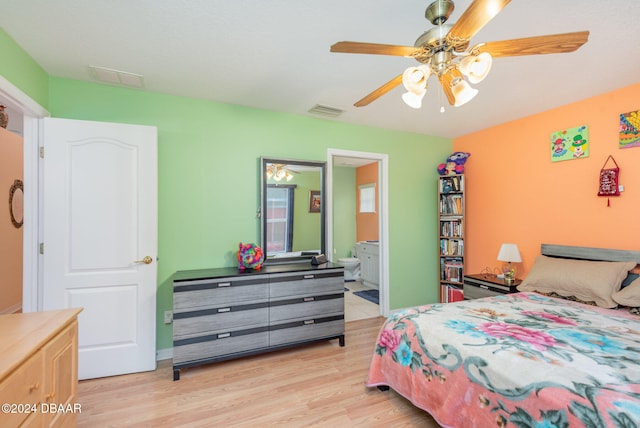 bedroom with ceiling fan, ensuite bath, and light hardwood / wood-style flooring