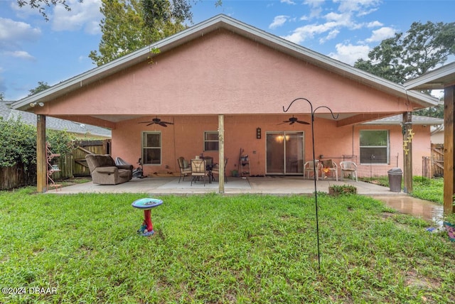 rear view of property with a lawn, ceiling fan, and a patio area