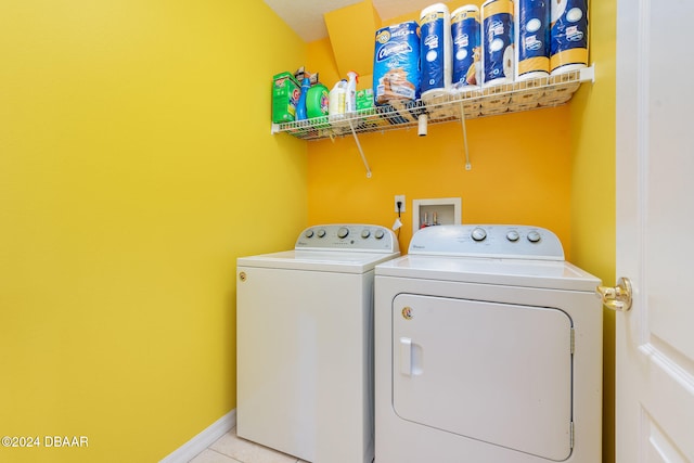 laundry area featuring light tile patterned flooring and washing machine and clothes dryer