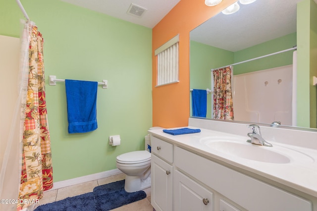 bathroom with tile patterned floors, vanity, toilet, and a textured ceiling