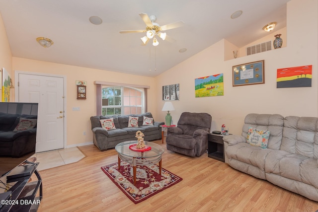 living room featuring ceiling fan, light hardwood / wood-style flooring, and vaulted ceiling