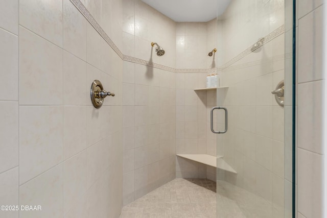 bathroom with a shower with door