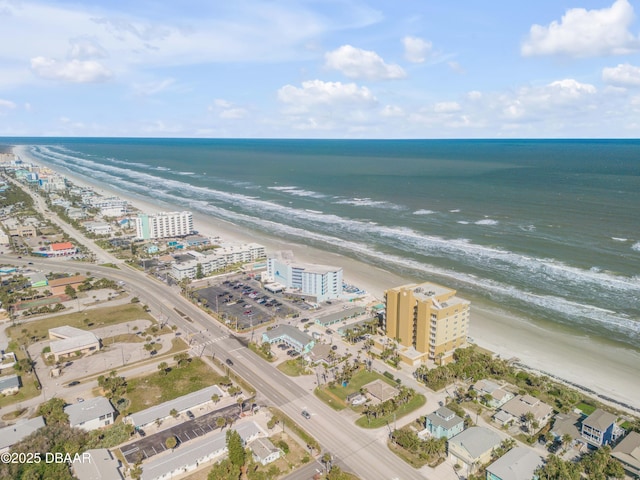 drone / aerial view featuring a view of the beach and a water view