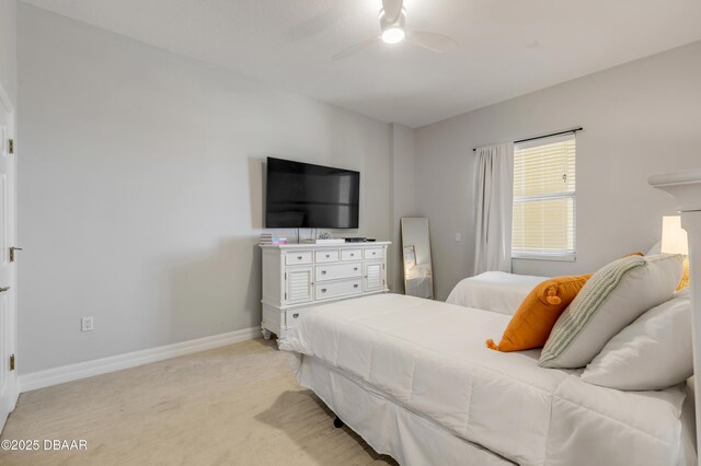 bedroom with ceiling fan and light colored carpet