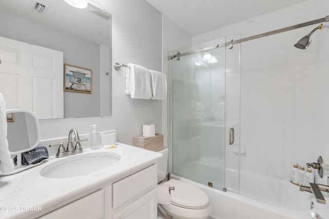 full bathroom featuring vanity, enclosed tub / shower combo, and toilet