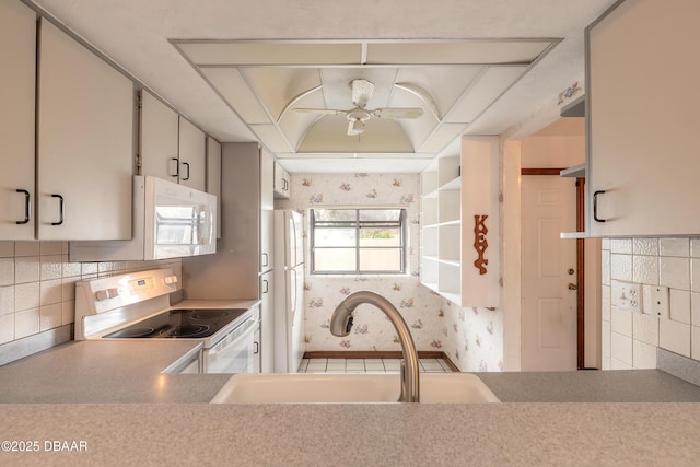1260 Charter Oaks Cir, Holly Hill, FL 32117 - kitchen featuring sink, white appliances, ceiling fan, white cabinetry, and decorative backsplash