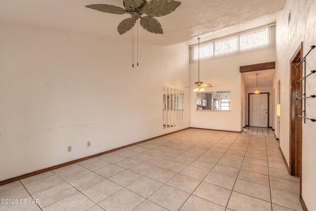 1260 Charter Oaks Cir, Holly Hill, FL 32117 - tiled empty room featuring a high ceiling and ceiling fan