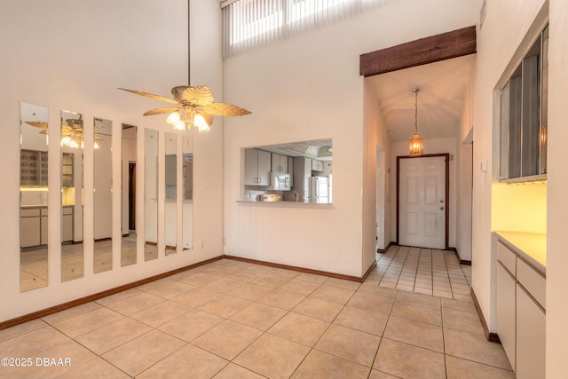 1260 Charter Oaks Cir, Holly Hill, FL 32117 - kitchen with light tile patterned floors, white appliances, ceiling fan, and a high ceiling