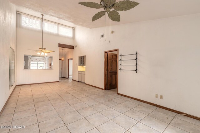 1260 Charter Oaks Cir, Holly Hill, FL 32117 - spare room featuring a towering ceiling, light tile patterned floors, and ceiling fan