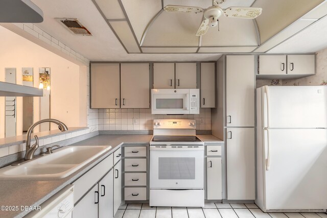 1260 Charter Oaks Cir, Holly Hill, FL 32117 - kitchen with ceiling fan, sink, white appliances, and decorative backsplash