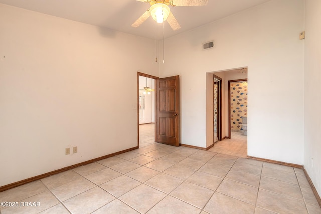 1260 Charter Oaks Cir, Holly Hill, FL 32117 - spare room with light tile patterned flooring, a towering ceiling, and ceiling fan