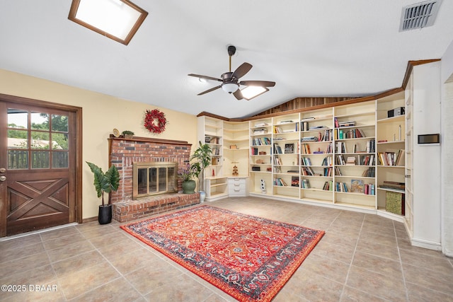 1 River Bluff Ct, Ormond Beach, FL 32174 - living room with vaulted ceiling, tile patterned flooring, a ceiling fan, and a brick fireplace