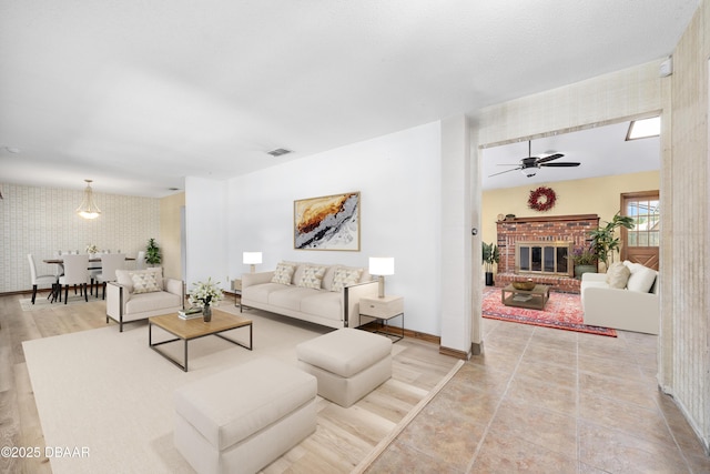 1 River Bluff Ct, Ormond Beach, FL 32174 - living area featuring wallpapered walls, ceiling fan, and a fireplace