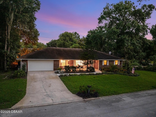 1 River Bluff Ct, Ormond Beach, FL 32174 - ranch-style house with concrete driveway, a yard, a garage, and brick siding