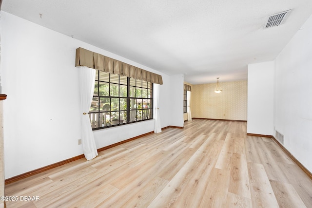 1 River Bluff Ct, Ormond Beach, FL 32174 - empty room featuring light wood-style floors and wallpapered walls