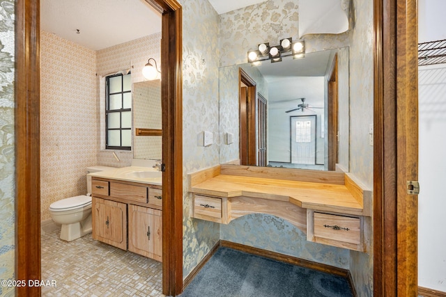 1 River Bluff Ct, Ormond Beach, FL 32174 - bathroom with vanity, wallpapered walls, and a ceiling fan