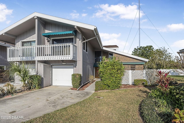 view of front of house with a garage, a balcony, and a front lawn