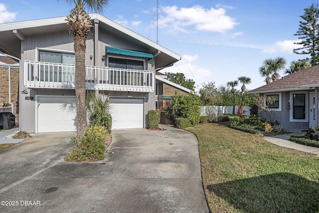 view of front of property with a garage, a balcony, and a front yard