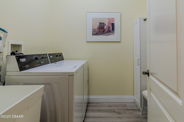 washroom featuring separate washer and dryer and light wood-type flooring