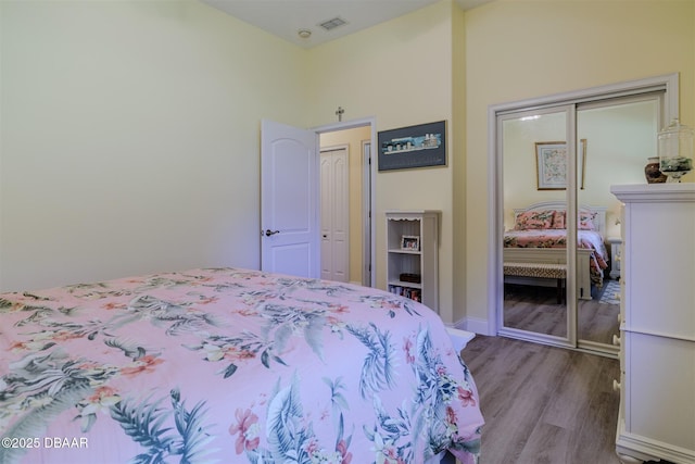 bedroom featuring wood-type flooring and a closet