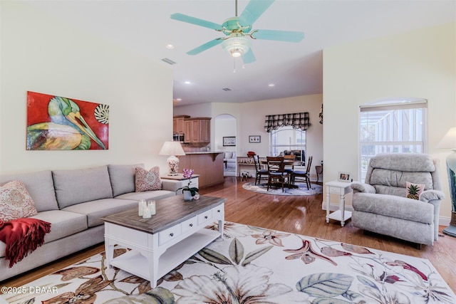 living room featuring ceiling fan and light wood-type flooring