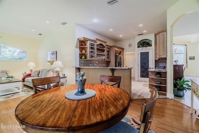 dining space featuring sink and light wood-type flooring