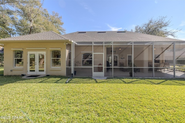 rear view of house featuring french doors, a yard, a patio area, and glass enclosure