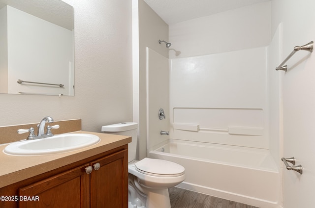 full bathroom with bathtub / shower combination, vanity, toilet, and wood-type flooring