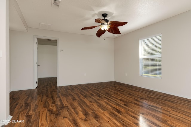 unfurnished room with ceiling fan and dark hardwood / wood-style flooring