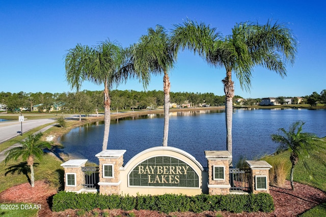 community sign featuring a water view