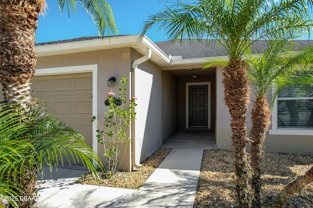 view of exterior entry with a garage