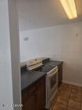 415 N Halifax Ave Unit 109, Daytona Beach, FL 32118 - kitchen featuring washer / dryer, tile patterned flooring, and dark countertops