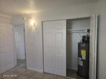 415 N Halifax Ave Unit 109, Daytona Beach, FL 32118 - unfurnished bedroom with a closet and tile patterned flooring