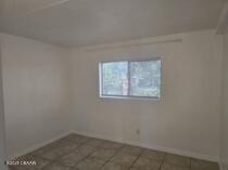 415 N Halifax Ave Unit 109, Daytona Beach, FL 32118 - spare room with tile patterned flooring and baseboards