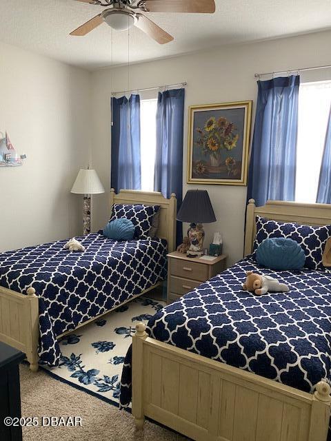 bedroom with a ceiling fan and carpet flooring