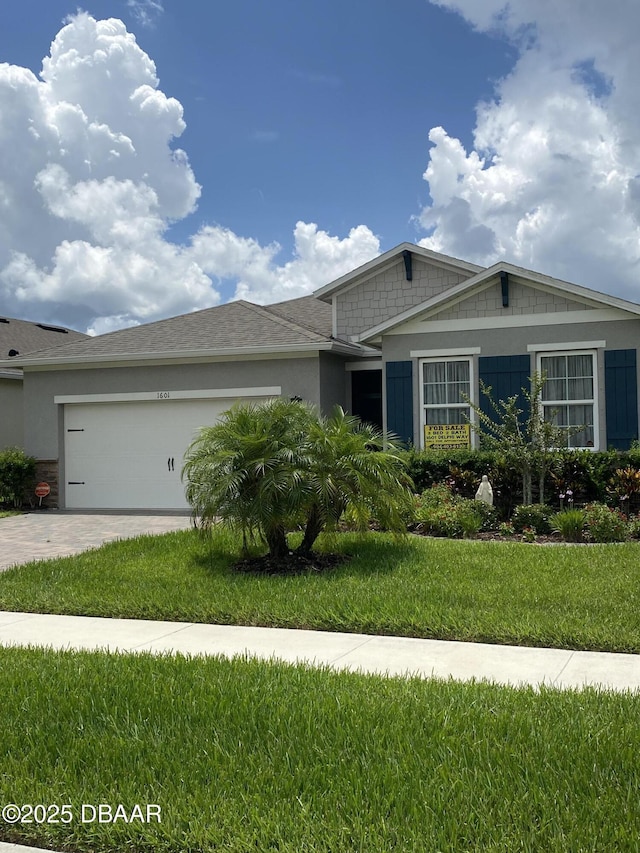 1601 Delphi Way, New Smyrna Beach, FL 32168 - view of front facade featuring an attached garage, driveway, and a front lawn