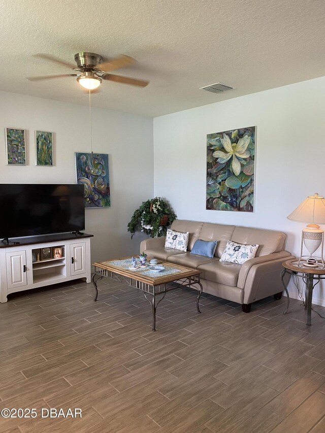 1601 Delphi Way, New Smyrna Beach, FL 32168 - living area with dark wood-style flooring, a ceiling fan, and a textured ceiling