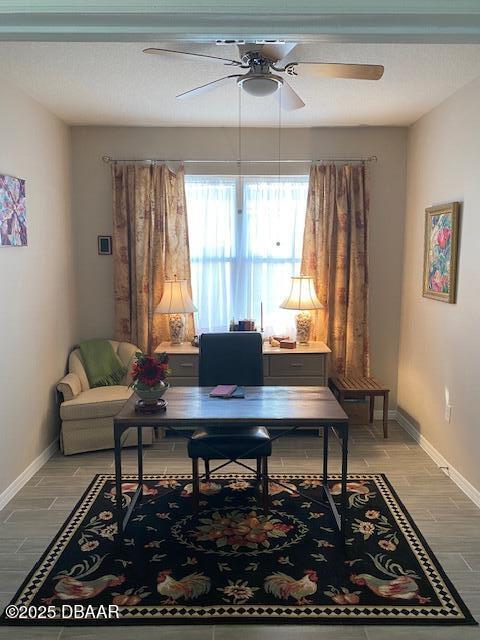 home office featuring ceiling fan, light wood finished floors, and baseboards