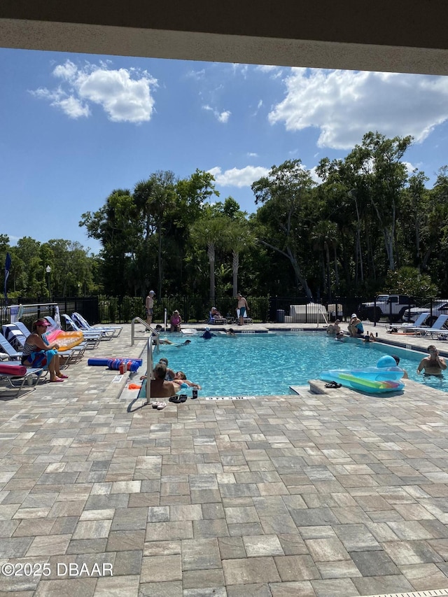 1601 Delphi Way, New Smyrna Beach, FL 32168 - community pool with a patio area and view of wooded area